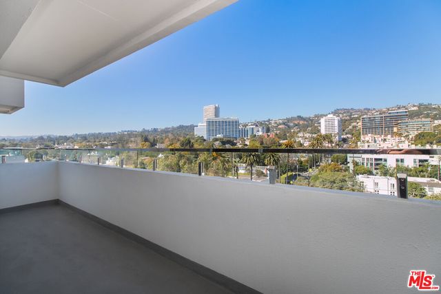 a kitchen with granite countertop white cabinets and a sink