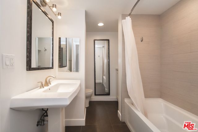 a bathroom with a bathtub and shower