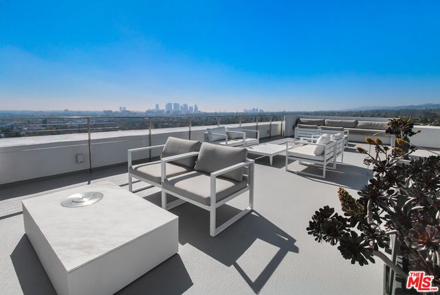 a roof deck with table and chairs