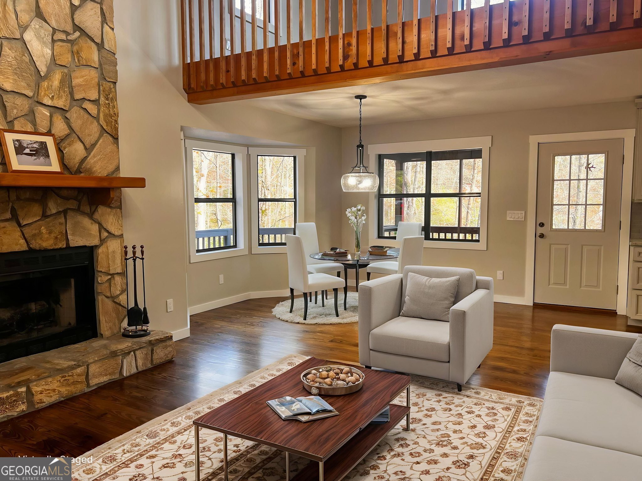 521 Northwind Sautee Nacoochee, GA 30571 - Photo 12 of 66 a living room with furniture a rug a fireplace and windows