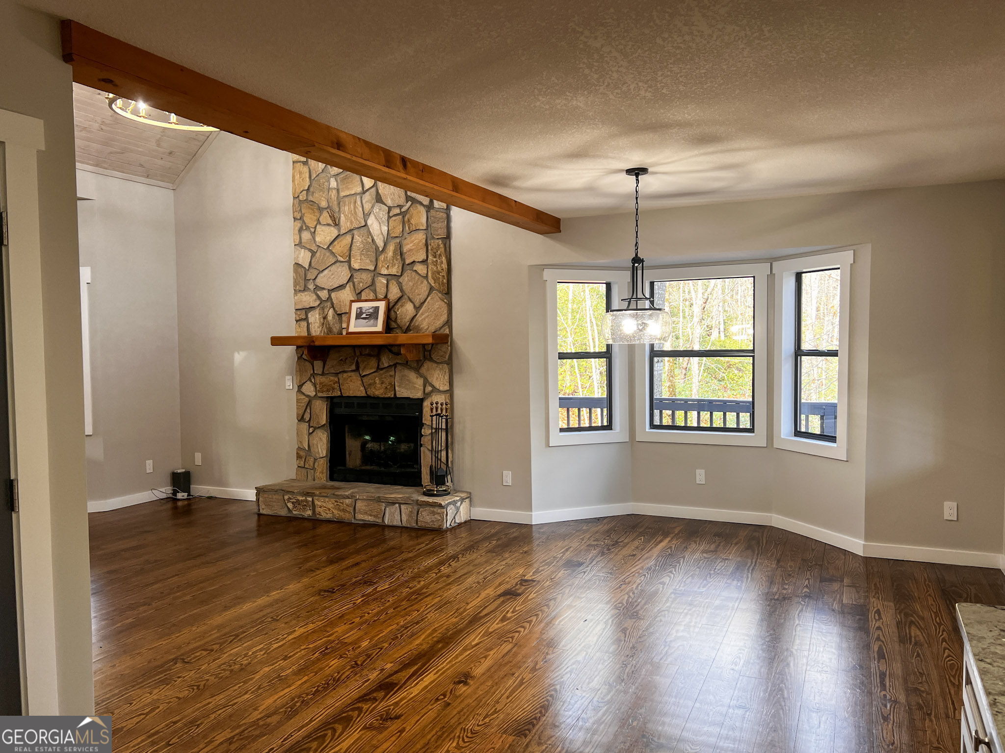 521 Northwind Sautee Nacoochee, GA 30571 - Photo 13 of 66 an empty room with windows and fireplace