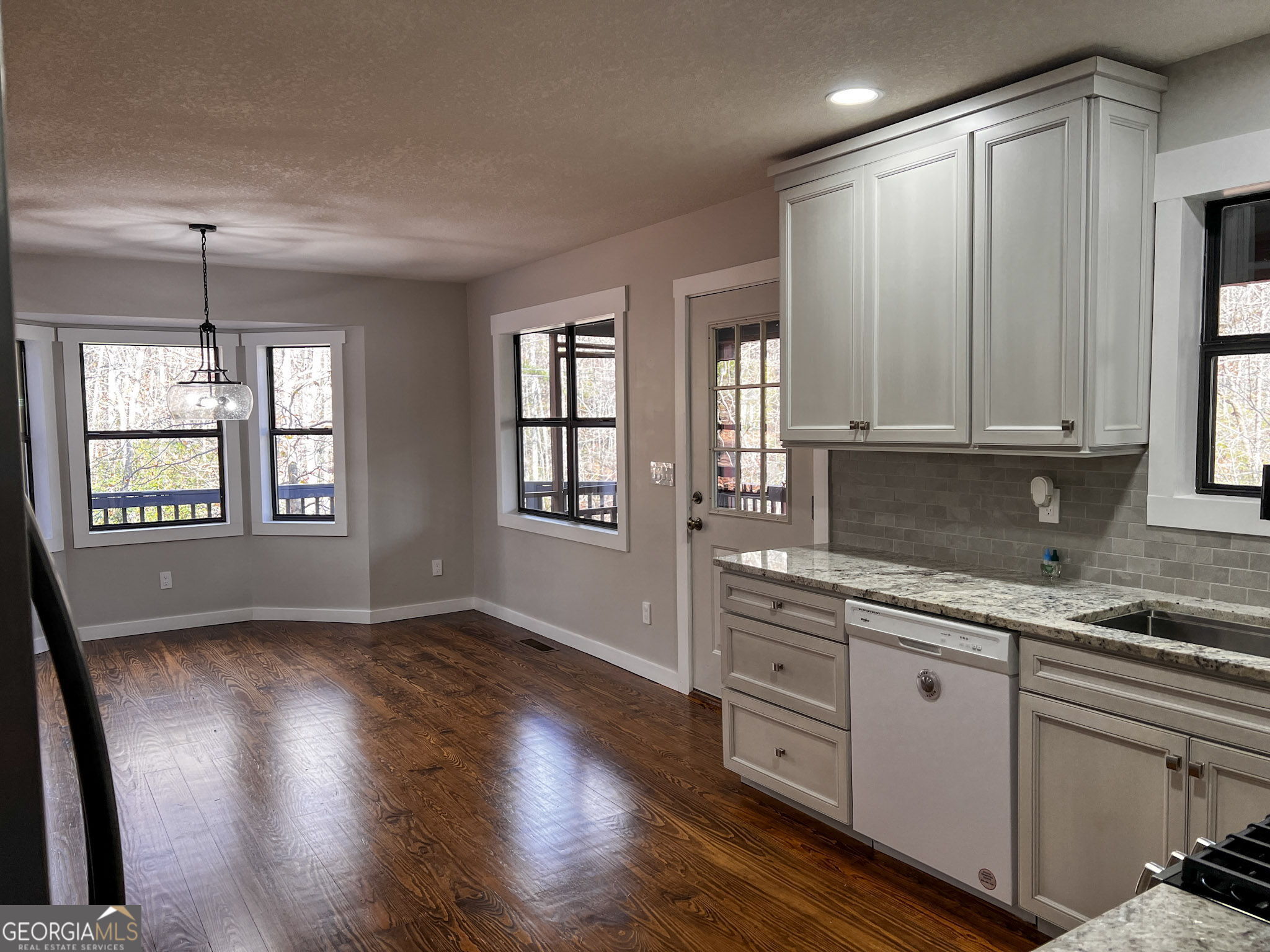 521 Northwind Sautee Nacoochee, GA 30571 - Photo 16 of 66 a kitchen with stainless steel appliances granite countertop cabinets wooden floors and white walls