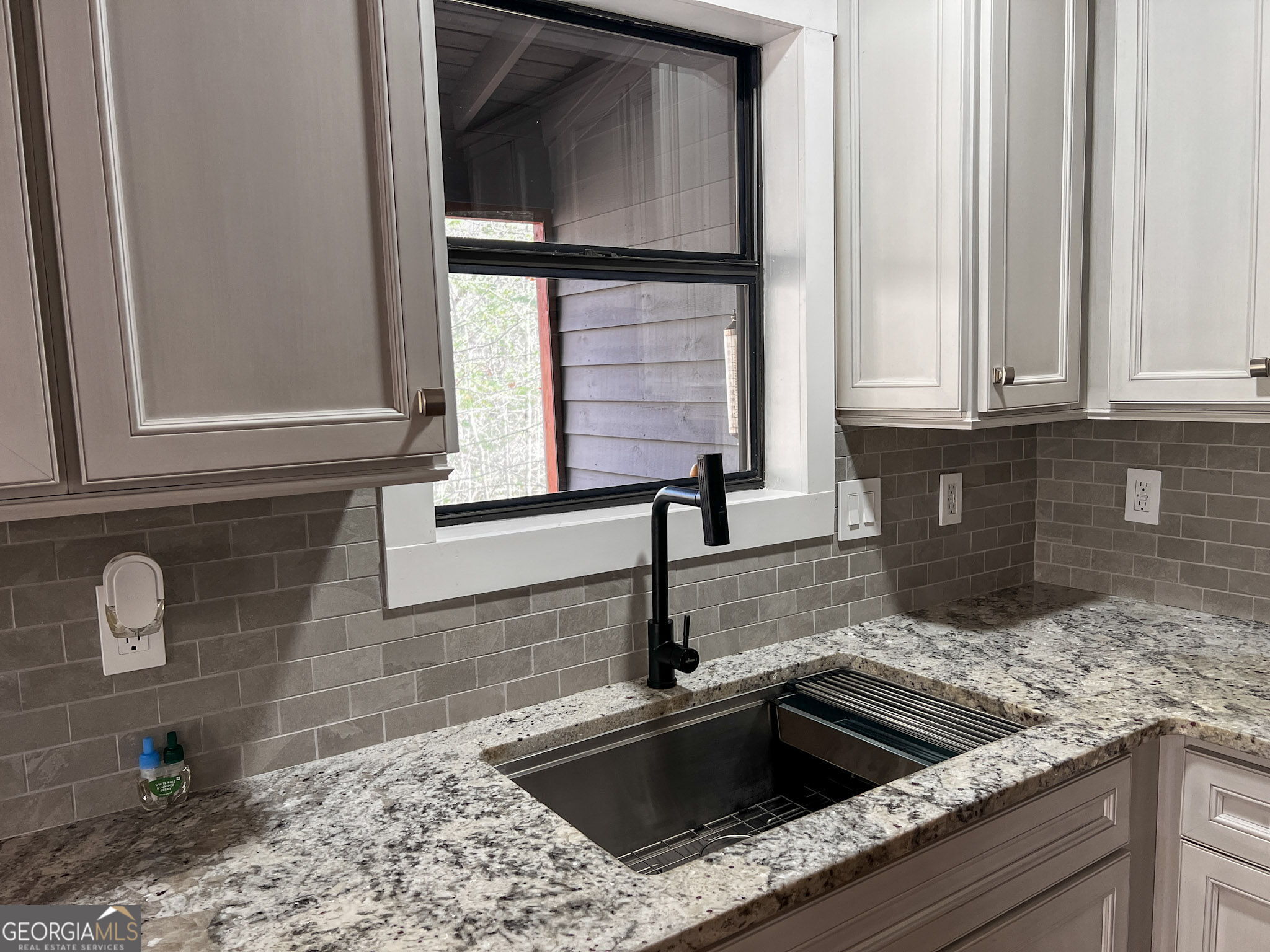 521 Northwind Sautee Nacoochee, GA 30571 - Photo 17 of 66 a kitchen with granite countertop a sink and a window