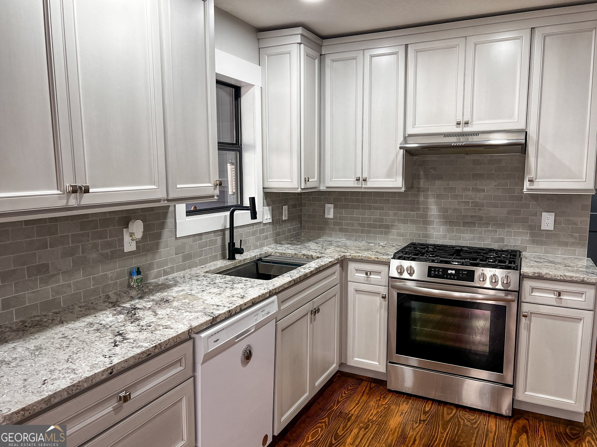 521 Northwind Sautee Nacoochee, GA 30571 - Photo 19 of 66 a kitchen with granite countertop stainless steel appliances white cabinets granite counter tops and a wooden floors