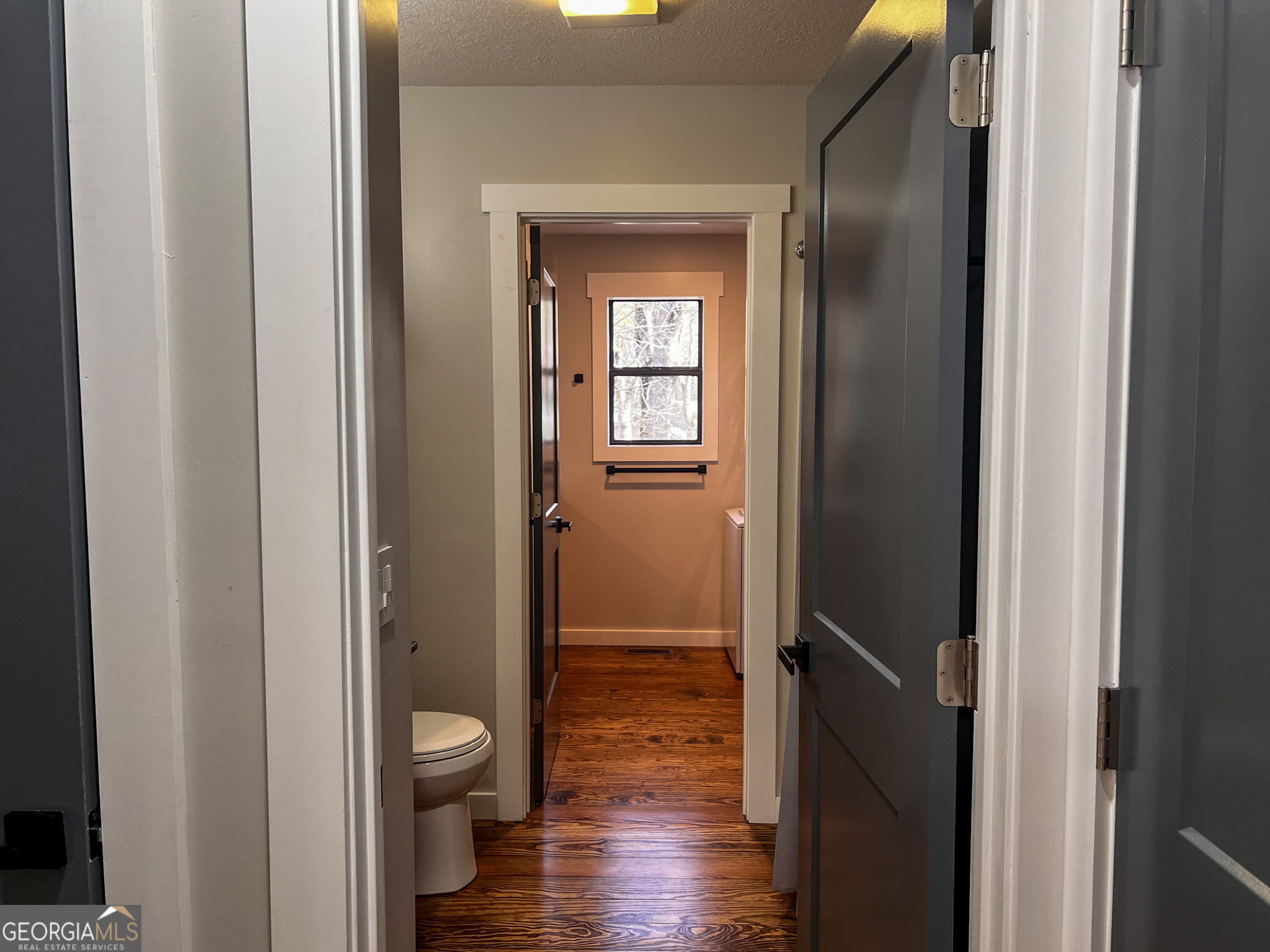 521 Northwind Sautee Nacoochee, GA 30571 - Photo 25 of 66 a view of a hallway with wooden floor a glass door and shower