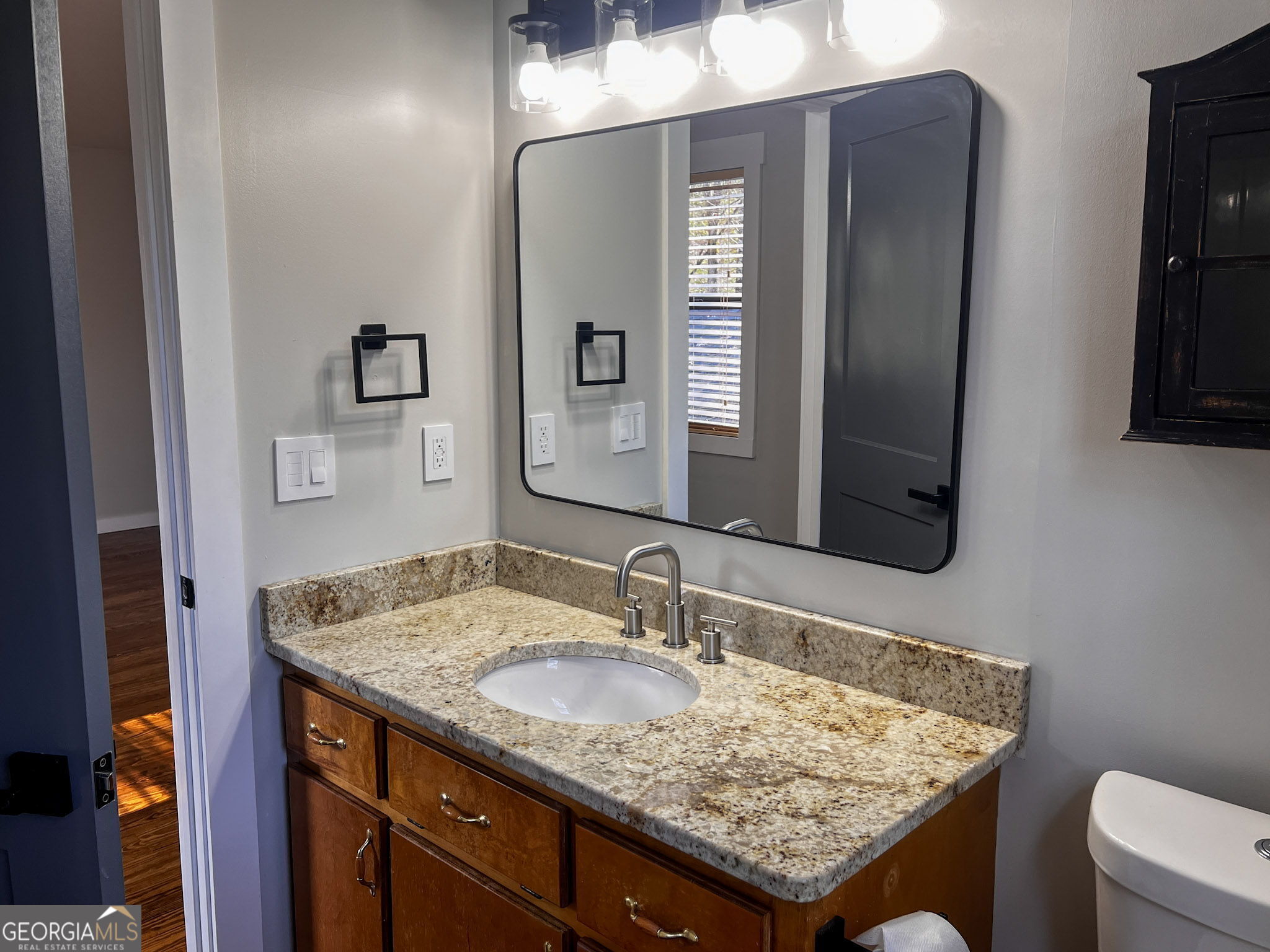 521 Northwind Sautee Nacoochee, GA 30571 - Photo 44 of 66 a bathroom with a granite countertop sink and a mirror