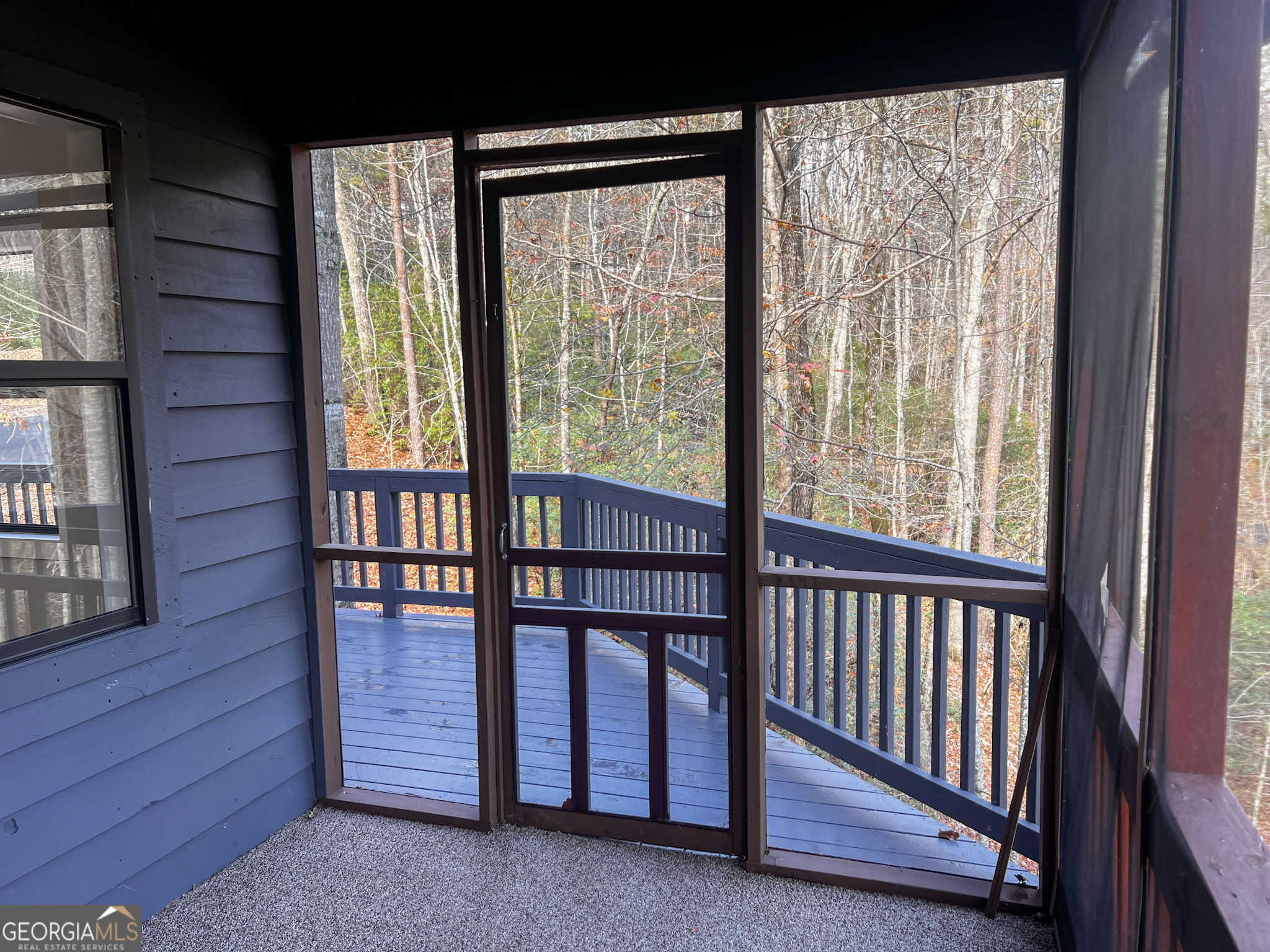 521 Northwind Sautee Nacoochee, GA 30571 - Photo 49 of 66 a view of a porch with wooden floor and a floor to ceiling window