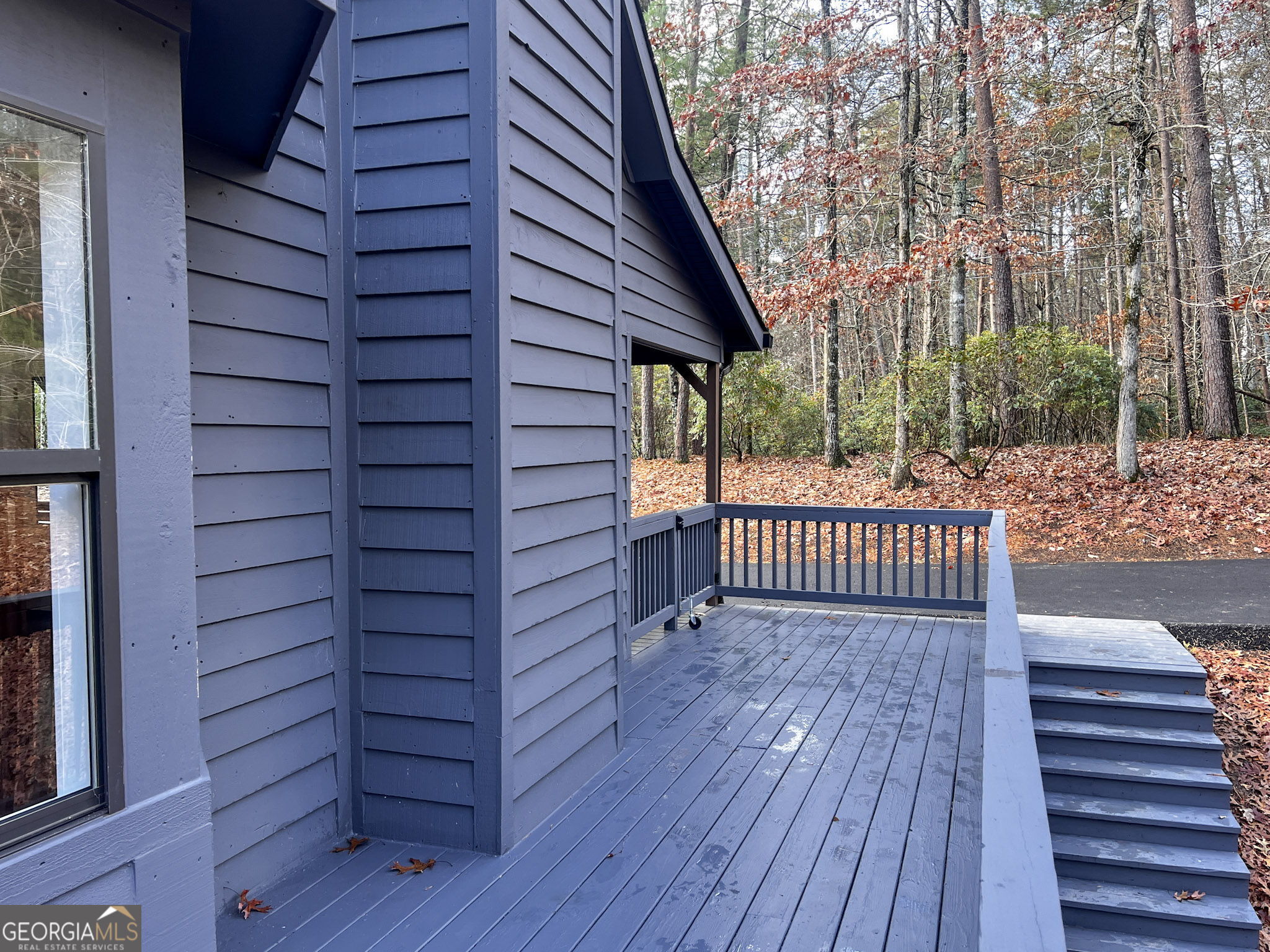 521 Northwind Sautee Nacoochee, GA 30571 - Photo 6 of 66 a view of a balcony with wooden floor and fence and a pot