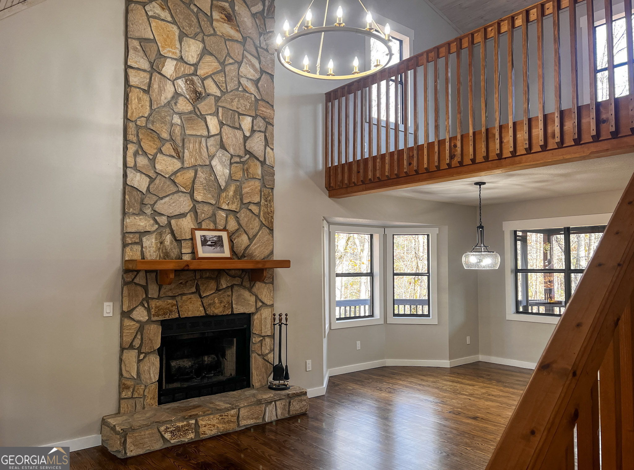 521 Northwind Sautee Nacoochee, GA 30571 - Photo 8 of 66 a view of an empty room with wooden floor fireplace and a window
