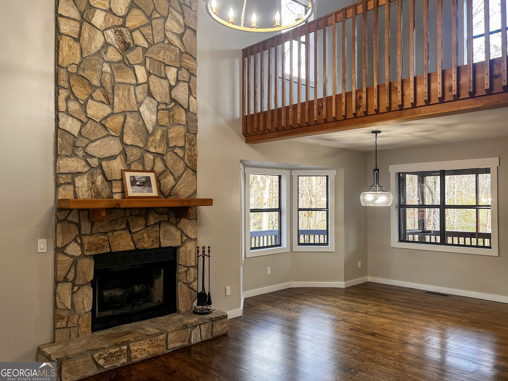 521 Northwind Sautee Nacoochee, GA 30571 - Photo 10 of 66 an empty room with wooden floor a fireplace and a window