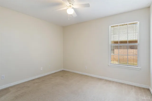 a view of an empty room with a fan