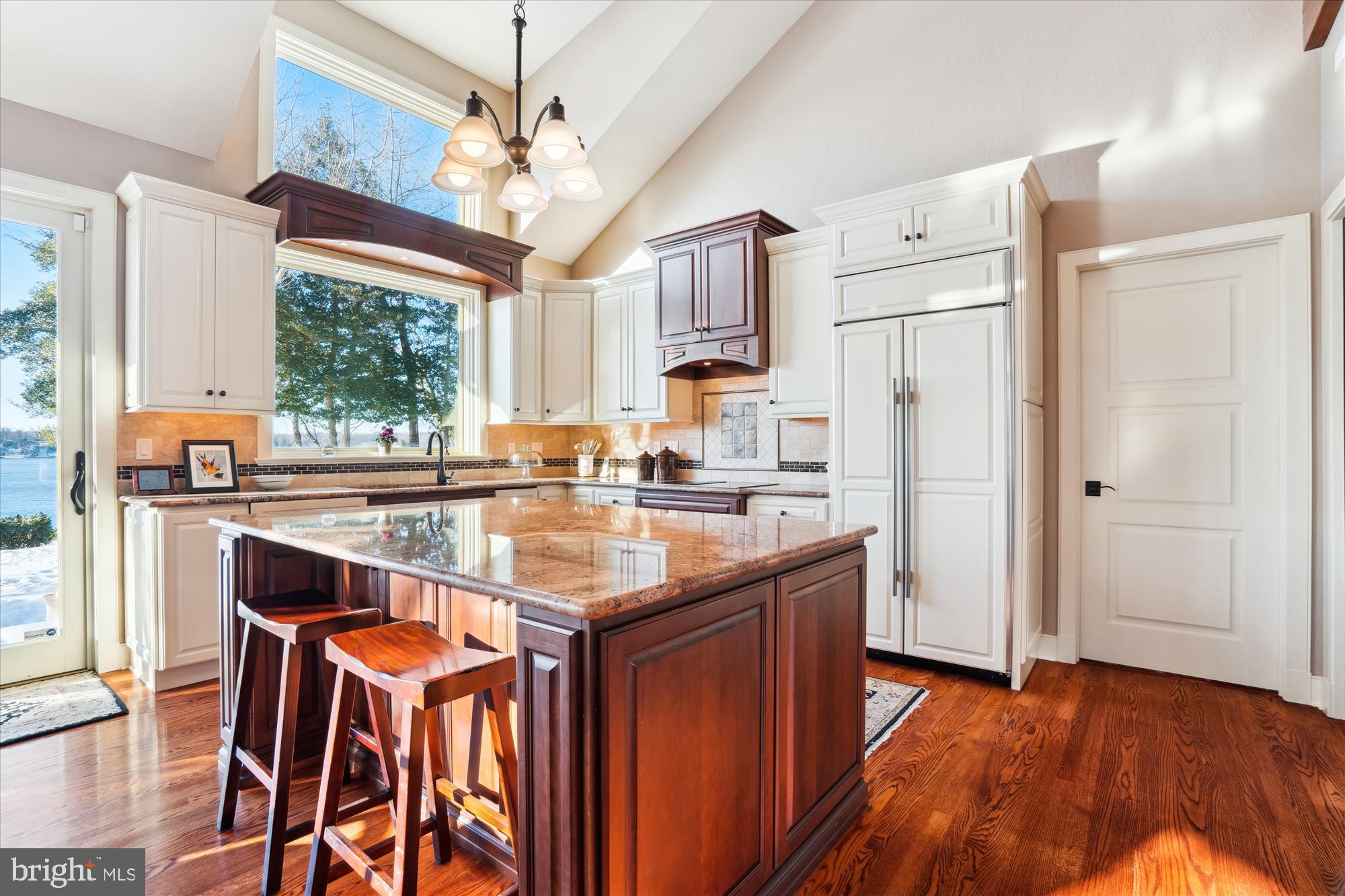 255 Long Point Road Crownsville, MD 21032 - Photo 18 of 67 a kitchen with stainless steel appliances granite countertop a refrigerator a sink dishwasher a stove and a dining table with wooden floor