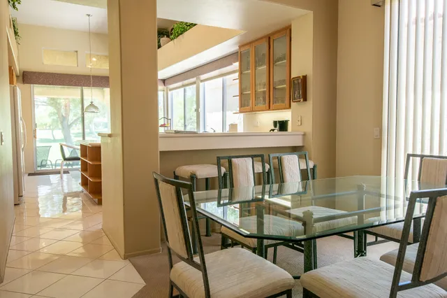 a view of a dining room with furniture and a window