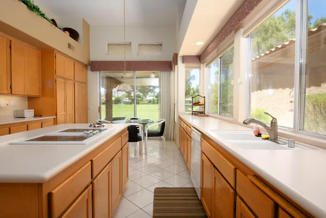 a kitchen with sink stove and cabinets