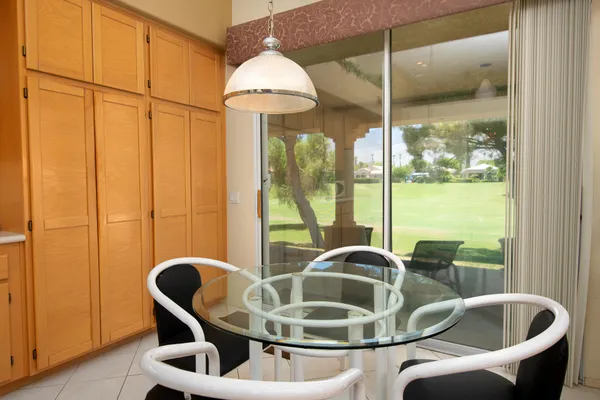 a kitchen with a table and chairs