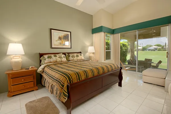 a spacious bedroom with a bed and a large window