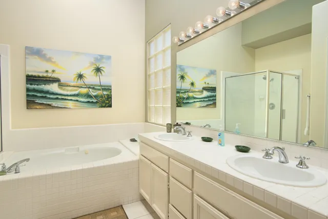 a bathroom with double vanity sinks and a bathtub