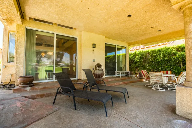 a view of a patio with table and chairs and potted plants