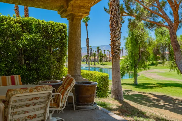 a view of backyard with seating area and green space