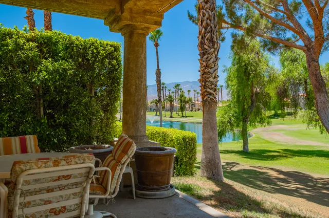 a view of backyard with seating area and green space