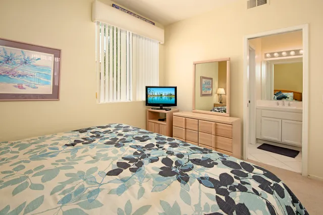 a bedroom with a bed and a view of kitchen