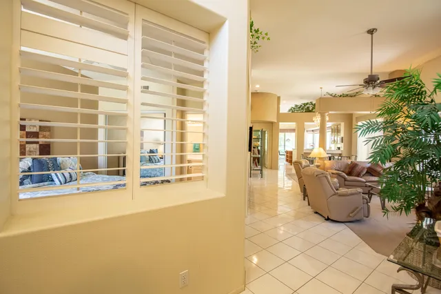 a living room with furniture and a floor to ceiling window