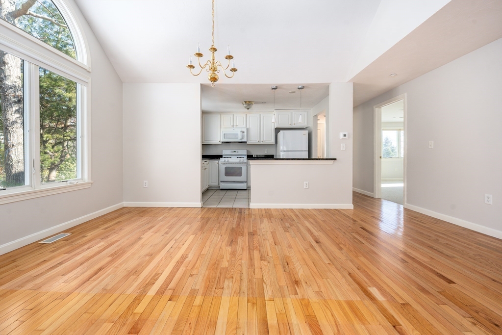 13 Pga Lane, Unit 424 Mashpee, MA 02649 - Photo 6 of 19 a view of a kitchen with wooden floor electronic appliances and windows