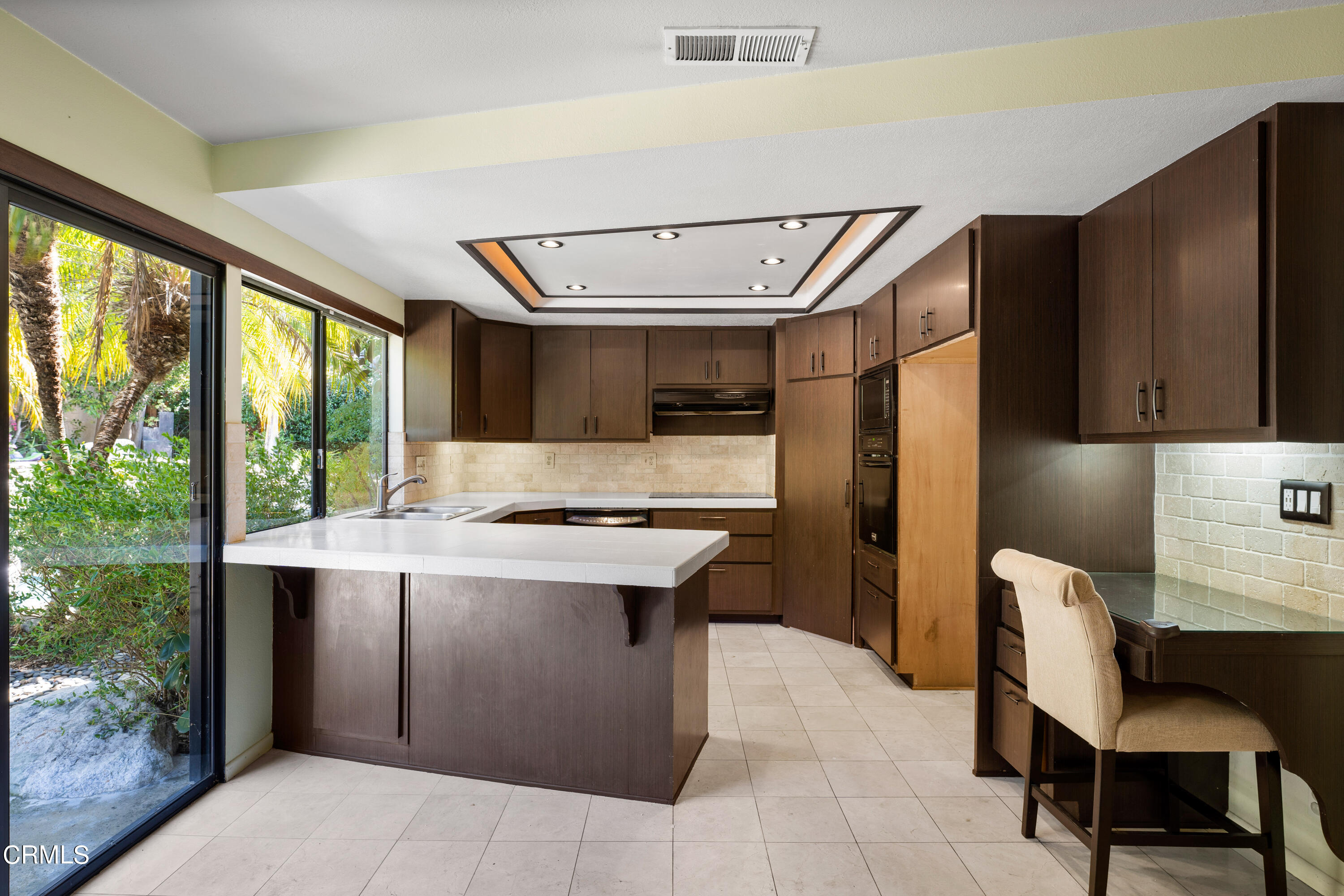 2210 Lyndhurst Avenue Camarillo, CA 93010 - Photo 18 of 37 a kitchen with a stove a refrigerator and a dining table