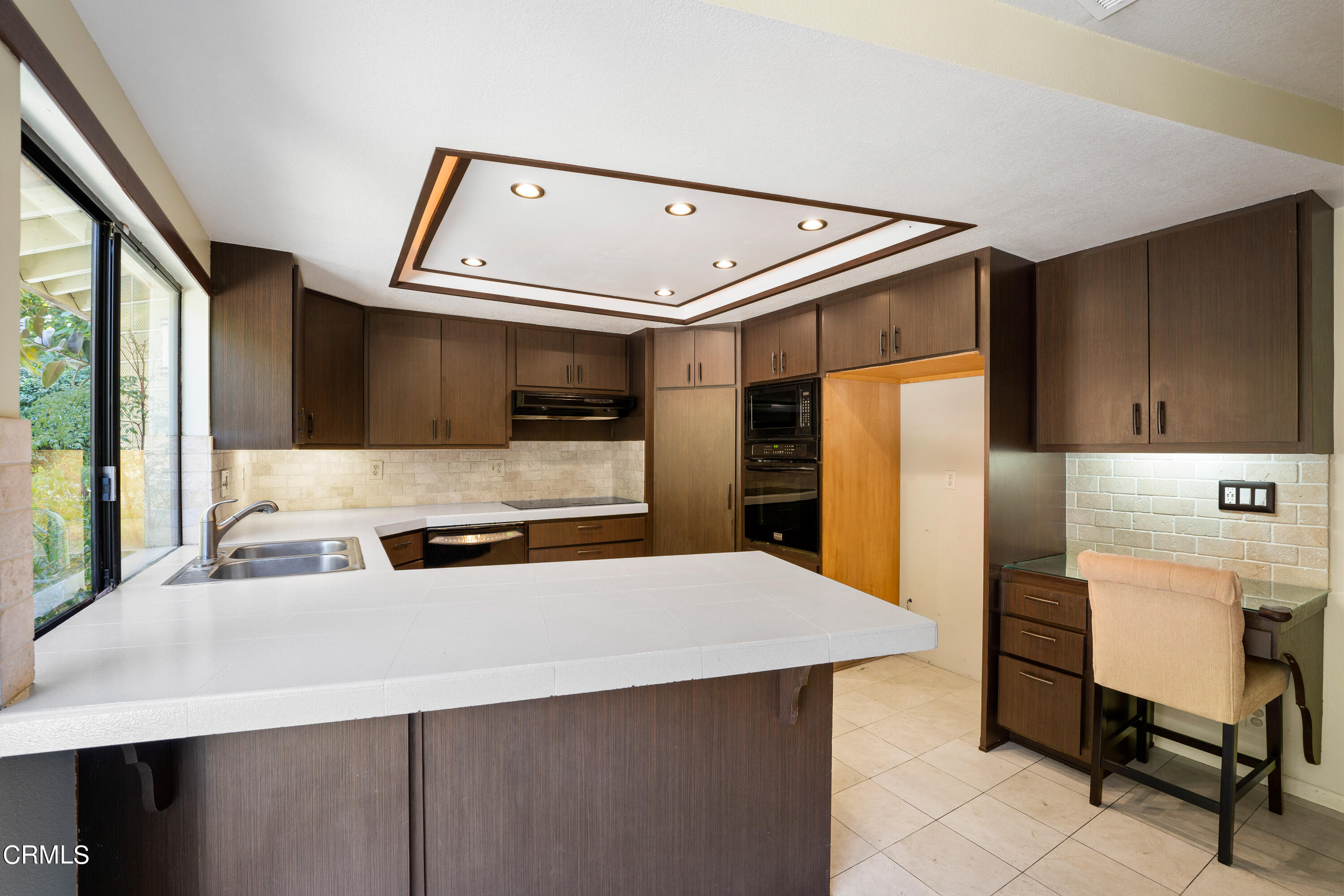2210 Lyndhurst Avenue Camarillo, CA 93010 - Photo 19 of 37 a kitchen with stainless steel appliances a sink and a refrigerator