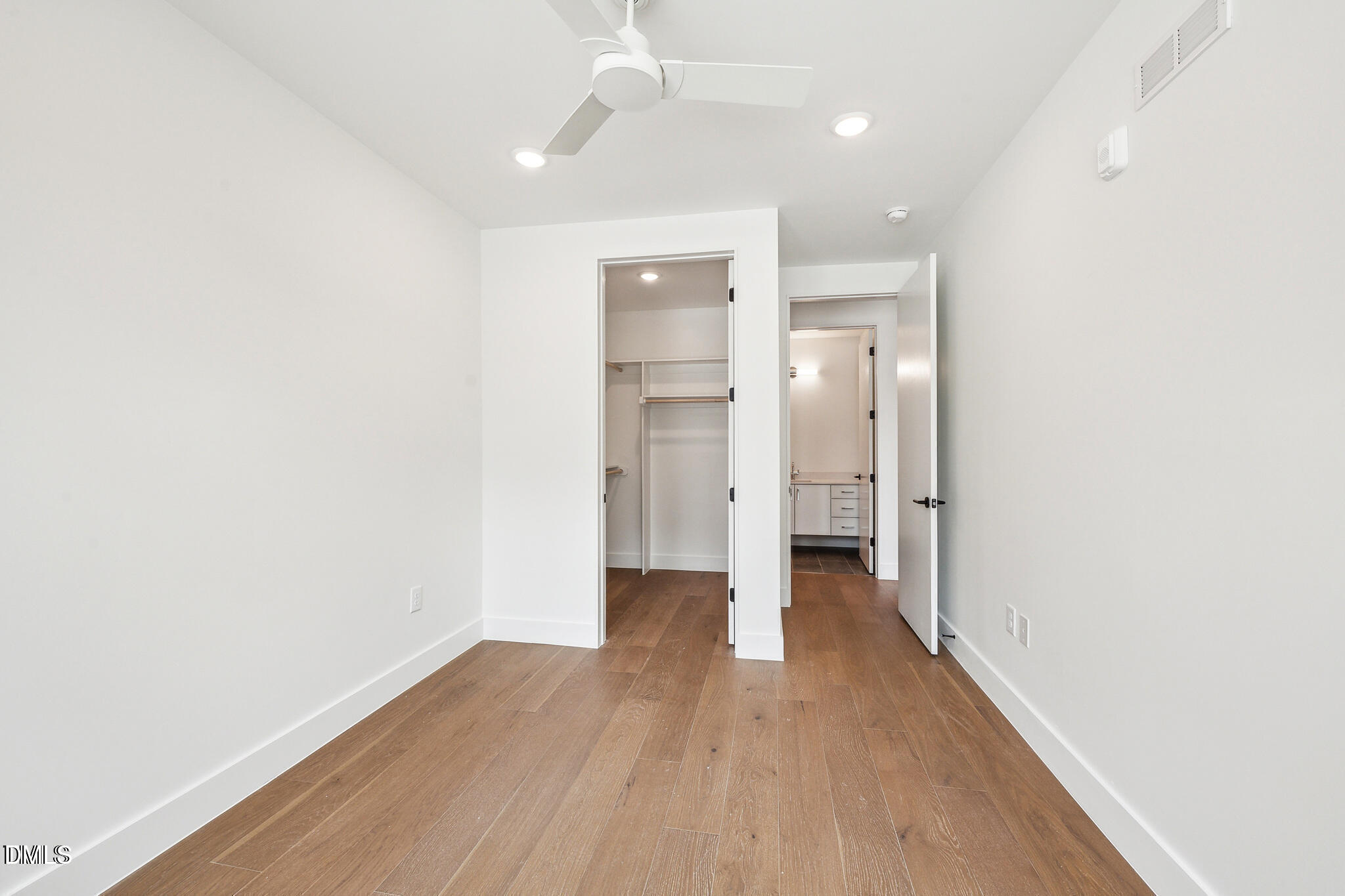 29 Enterprise Street, Unit 109 Raleigh, NC 27607 - Photo 13 of 18 a view of an empty room with wooden floor