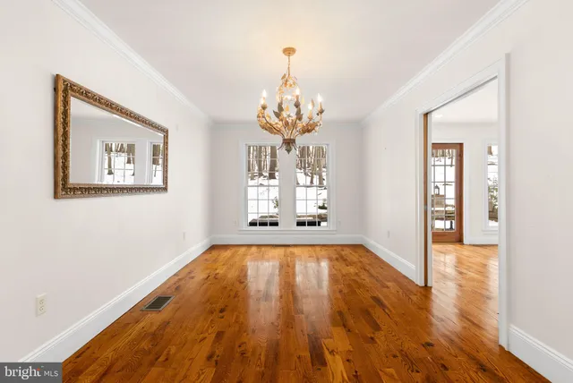 a living room with fireplace furniture and a large window