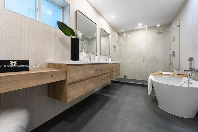 a bathroom with a bathtub sink and mirror