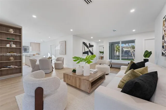 a living room with furniture and a potted plant