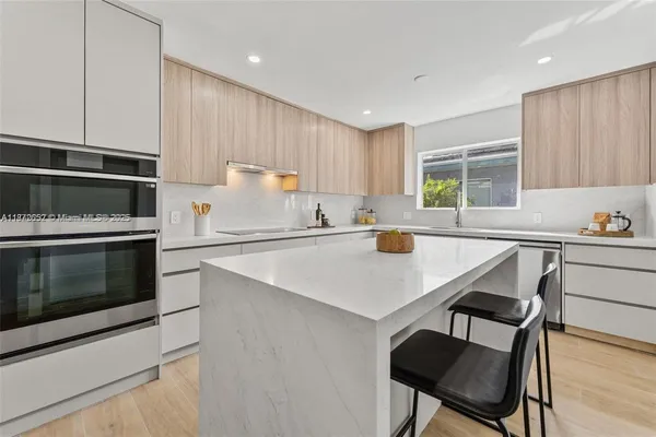 a kitchen with a stove a sink and a microwave