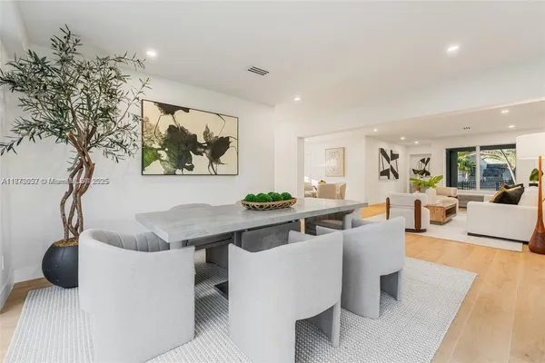 a living room with furniture a table and a potted plant