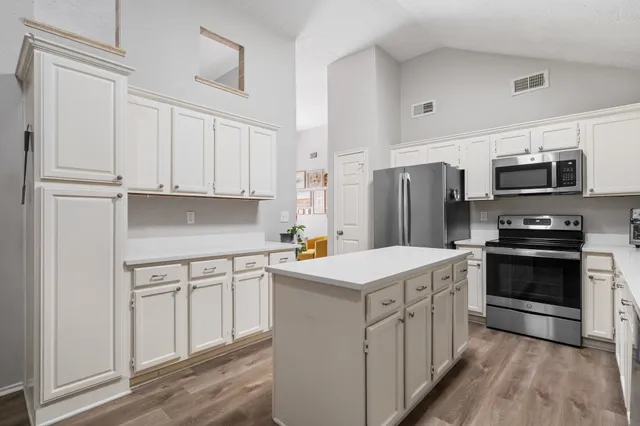 a kitchen with stainless steel appliances a stove refrigerator sink and microwave