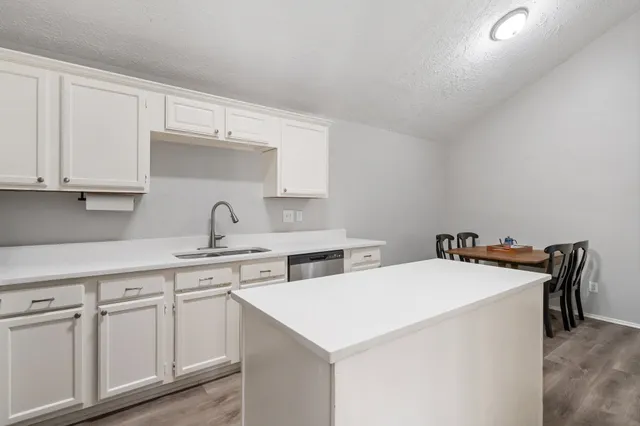 a utility room with sink and cabinets