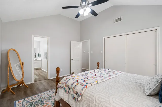 a bedroom with a bed and a chandelier