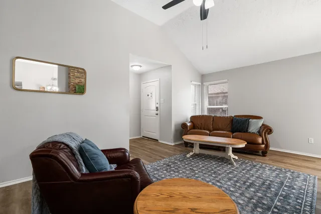 a living room with furniture a rug and a window