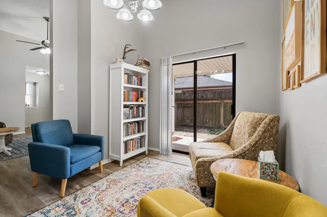 a living room with furniture a rug and a large window