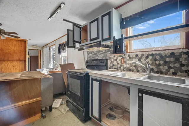 a kitchen with stainless steel appliances granite countertop a sink and cabinets