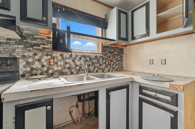 a utility room with a sink and a stove