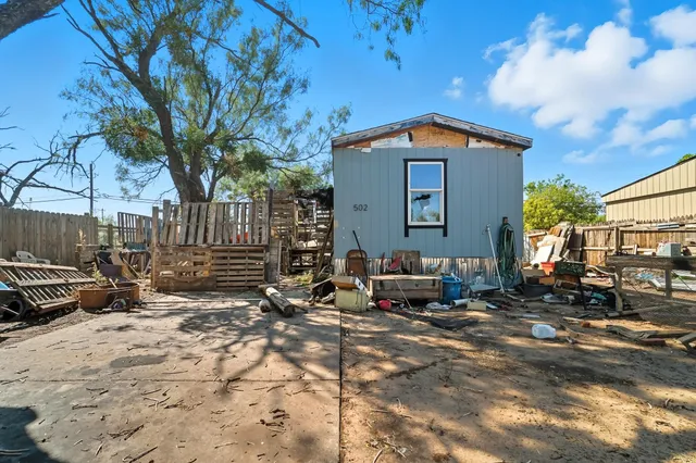 a view of a backyard with sitting area
