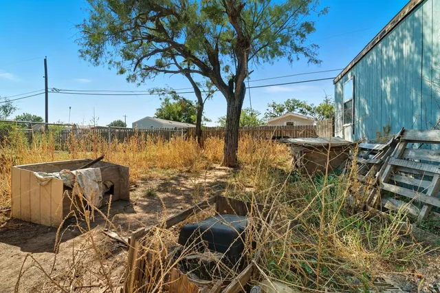 a backyard of a house with barbeque oven and outdoor seating