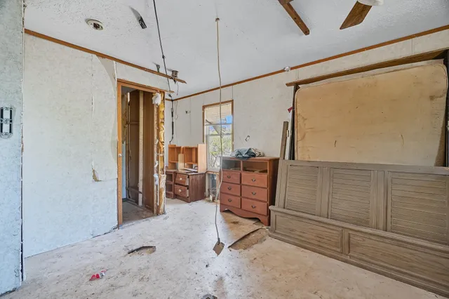 a room with lots of furniture and white walls