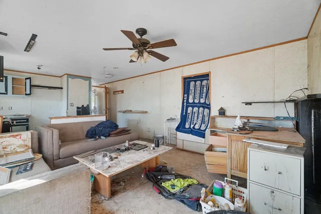 a living room with furniture and kitchen view