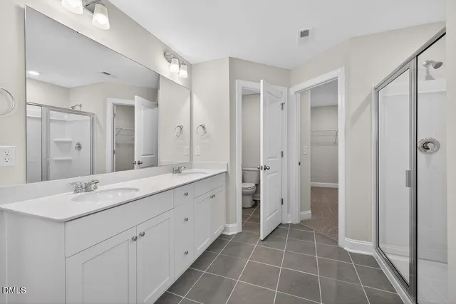 a spacious bathroom with a tub shower and a sink