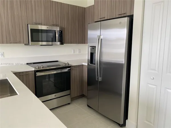 a kitchen with a refrigerator stove and microwave