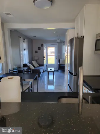 a view of a livingroom with furniture and a flat screen tv