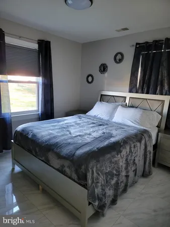 a bed sitting in a bedroom next to a window